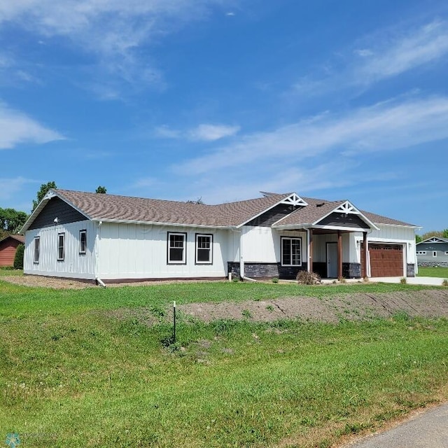 single story home with a front yard and a garage