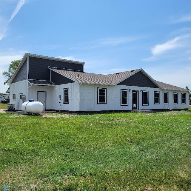 back of house with a lawn