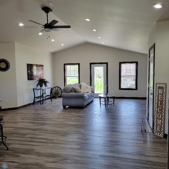 living room with ceiling fan, dark hardwood / wood-style flooring, and lofted ceiling