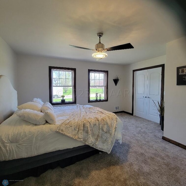 carpeted bedroom with a closet and ceiling fan