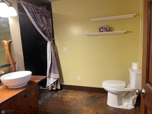 bathroom featuring toilet and vanity