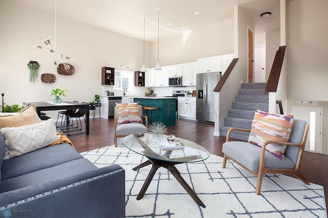 living room with high vaulted ceiling and hardwood / wood-style floors