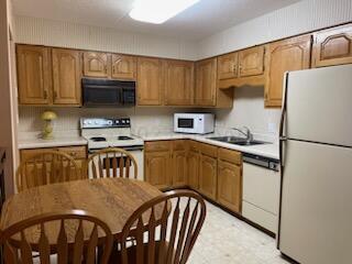 kitchen with white appliances and sink