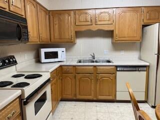 kitchen with sink, white appliances, and light tile floors