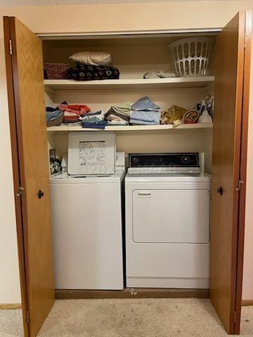 washroom featuring independent washer and dryer and light carpet