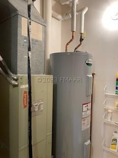 utility room featuring water heater