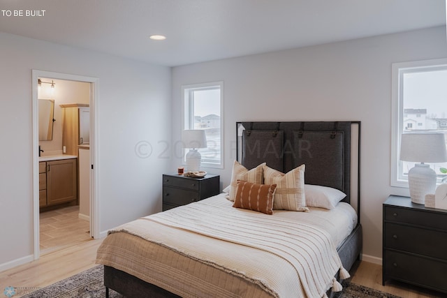 tiled bedroom featuring sink and ensuite bathroom