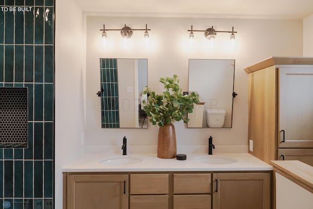 bathroom with dual bowl vanity and toilet