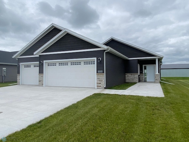 craftsman-style home with a front yard and a garage