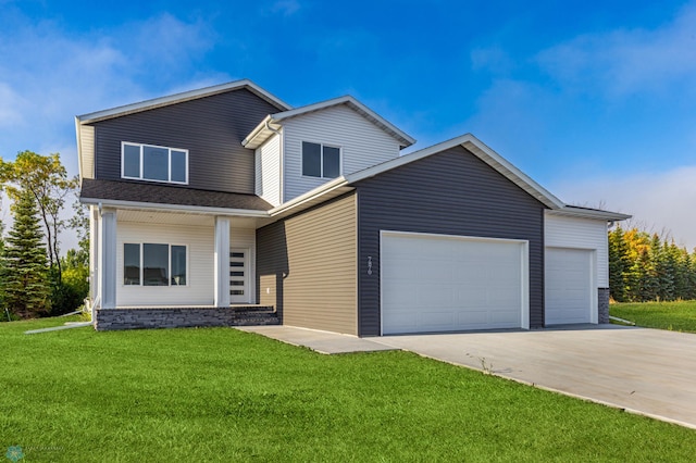 view of front of house with a garage and a front lawn