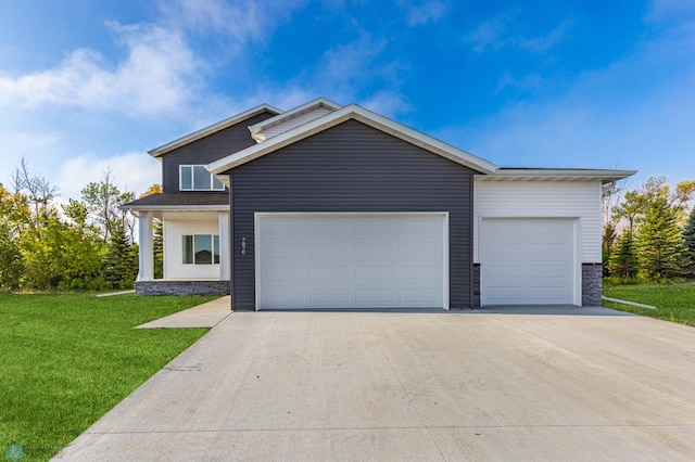 view of front of house with a garage and a front lawn