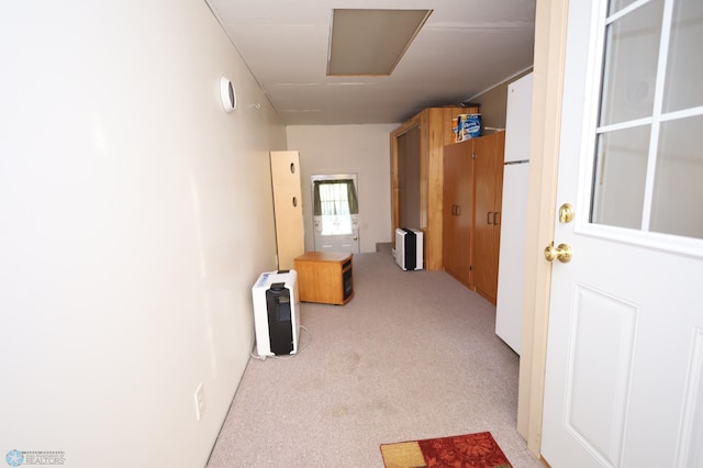 interior space featuring light carpet and heating unit