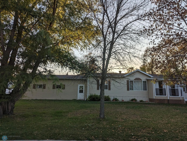 ranch-style house featuring a yard