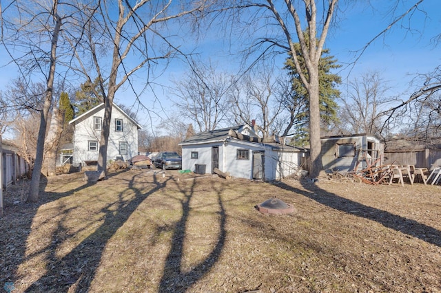 rear view of house with a yard and an outdoor structure