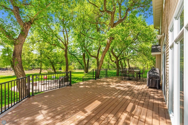 wooden deck with a grill