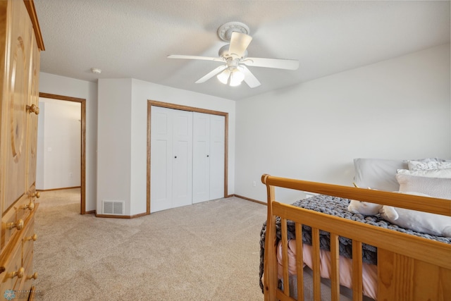 carpeted bedroom with a closet and ceiling fan