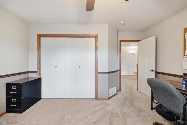 office space with light colored carpet and ceiling fan