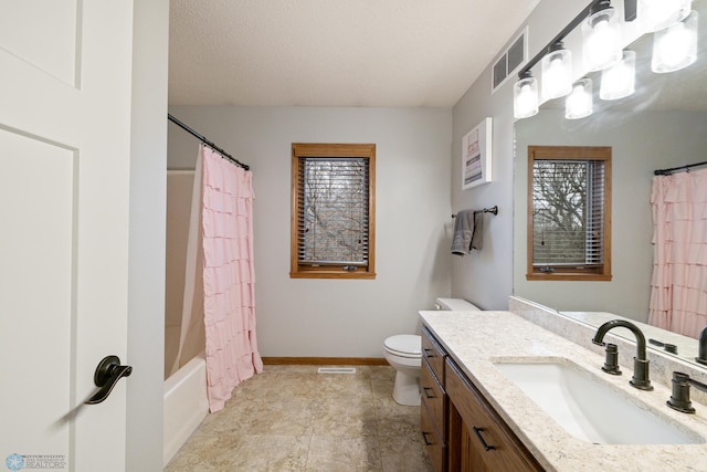 full bathroom with shower / tub combo with curtain, vanity, tile patterned flooring, and toilet