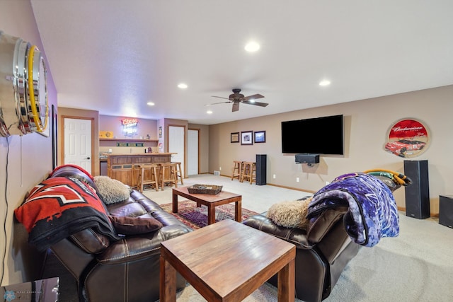 carpeted living room with bar area and ceiling fan