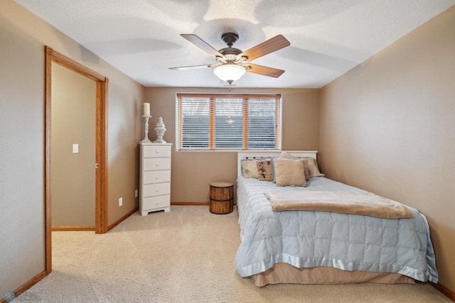 bedroom featuring light carpet and ceiling fan