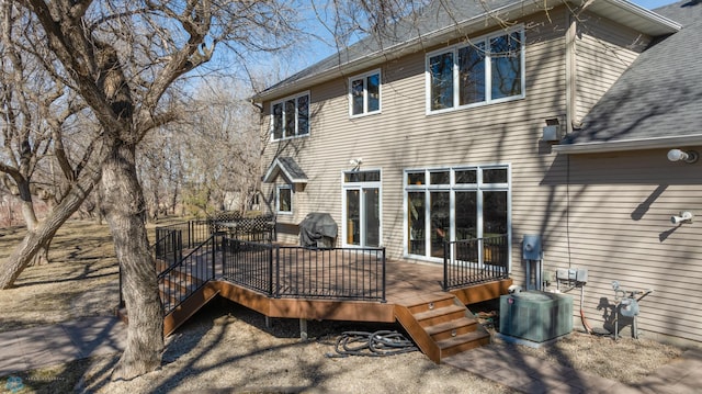 back of property featuring a deck and central AC unit