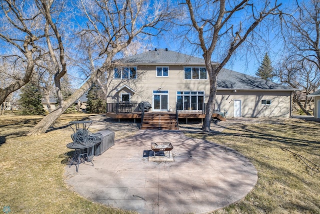 rear view of property with a deck, a patio area, and a yard