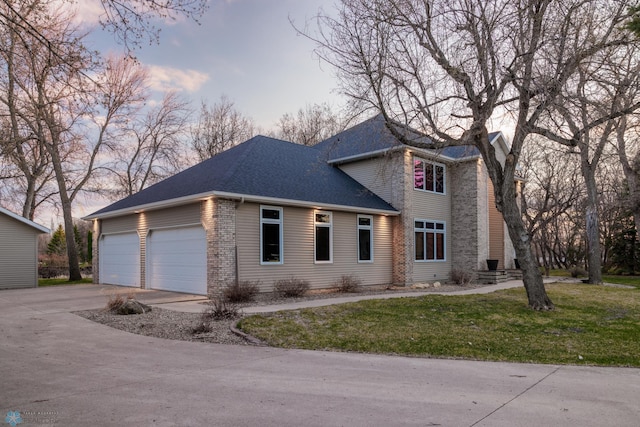 view of front of home with a garage and a yard