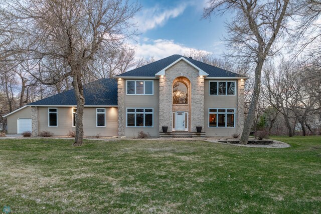 view of front of property with a garage and a front lawn