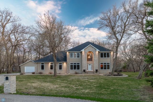 view of front of house featuring a garage and a front lawn