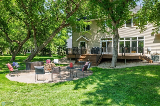 back of property featuring a patio, a deck, and a lawn