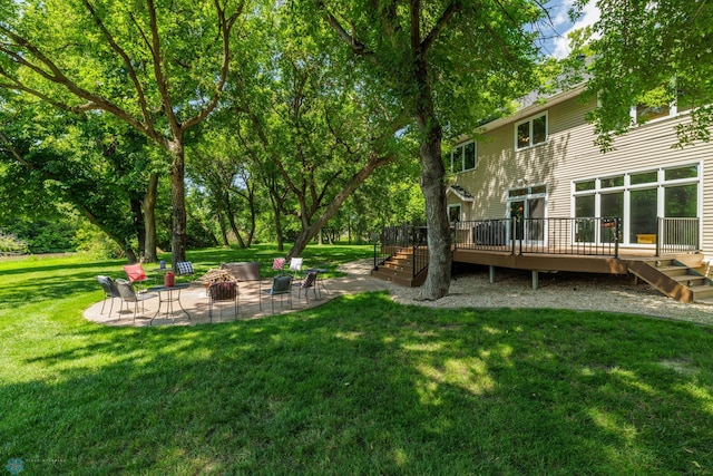 view of yard with an outdoor fire pit, a patio area, and a deck