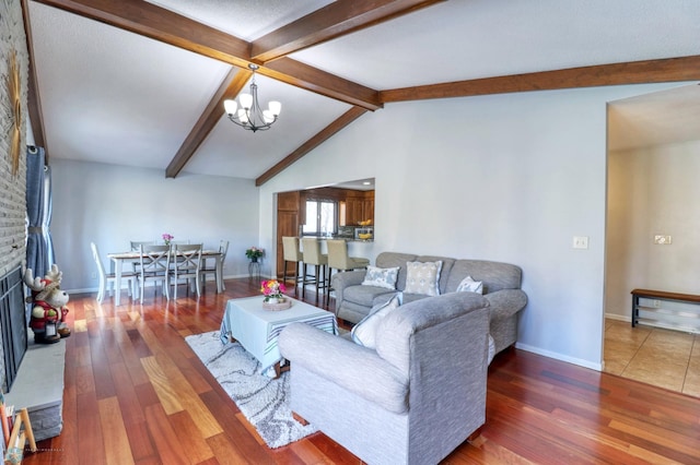 living room featuring a fireplace, an inviting chandelier, vaulted ceiling with beams, and hardwood / wood-style flooring