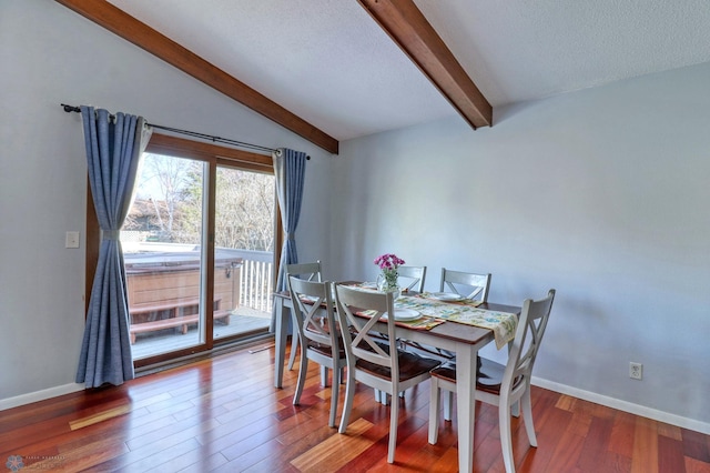 dining room featuring hardwood / wood-style floors, lofted ceiling with beams, and a textured ceiling