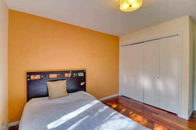 bedroom featuring hardwood / wood-style floors and a closet