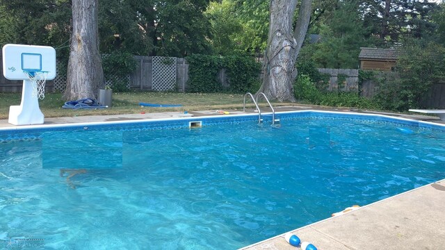 view of pool featuring a diving board