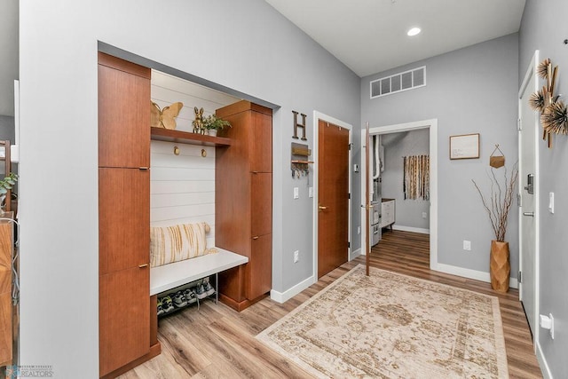 mudroom with light hardwood / wood-style floors