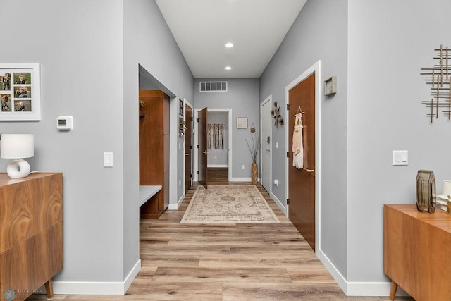 corridor with light hardwood / wood-style flooring