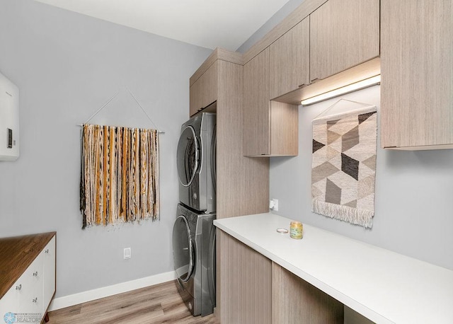 kitchen with light brown cabinetry, light hardwood / wood-style floors, and stacked washing maching and dryer