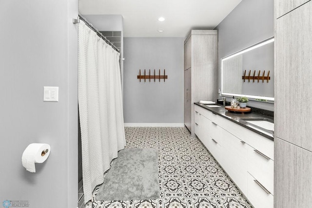 bathroom featuring tile floors and double vanity