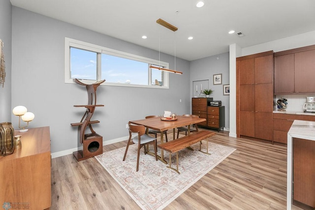 dining space with light wood-type flooring