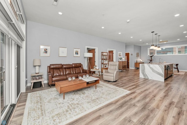 living room featuring light hardwood / wood-style flooring and sink