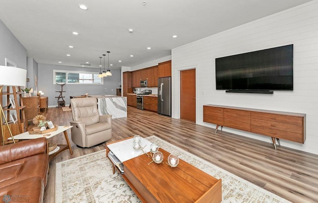 living room featuring sink and light wood-type flooring