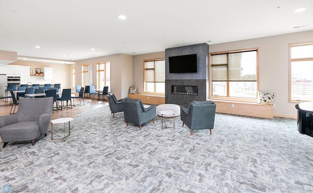 living room with a large fireplace and a wealth of natural light