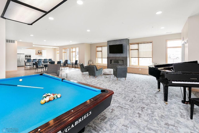 game room featuring billiards, light carpet, and a large fireplace