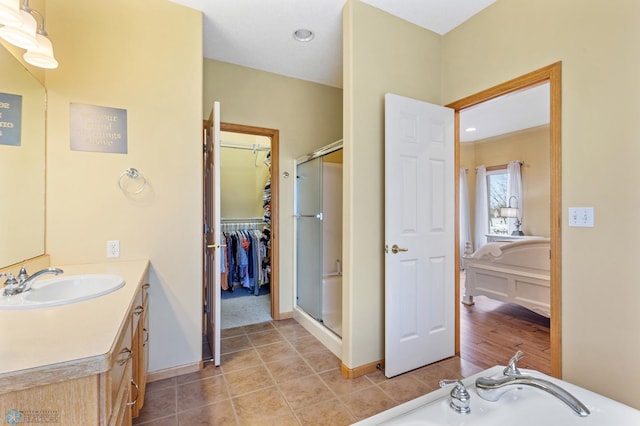 bathroom with tile patterned floors, vanity, and a shower with shower door