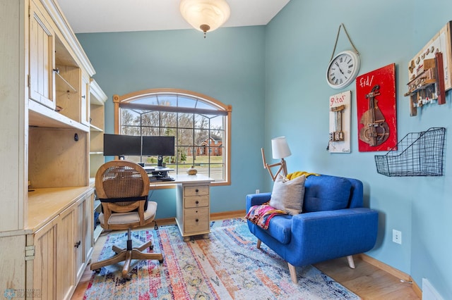 home office with light hardwood / wood-style floors