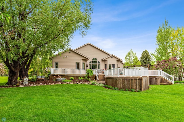 back of house with a wooden deck and a yard