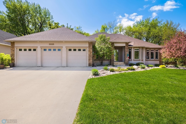 view of front facade with a garage and a front lawn