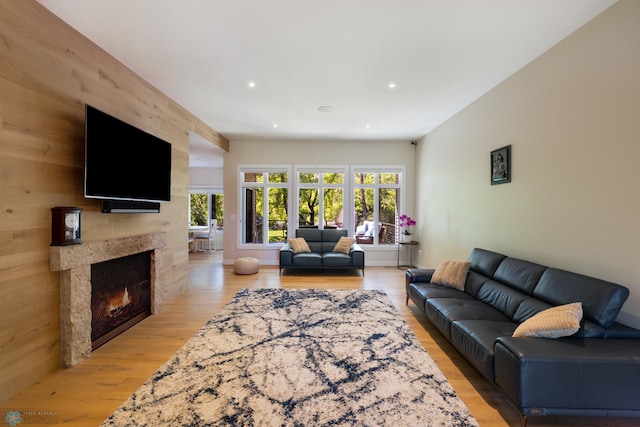 living room with wooden walls and hardwood / wood-style flooring