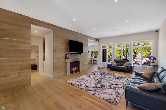 living room with hardwood / wood-style floors and wooden walls